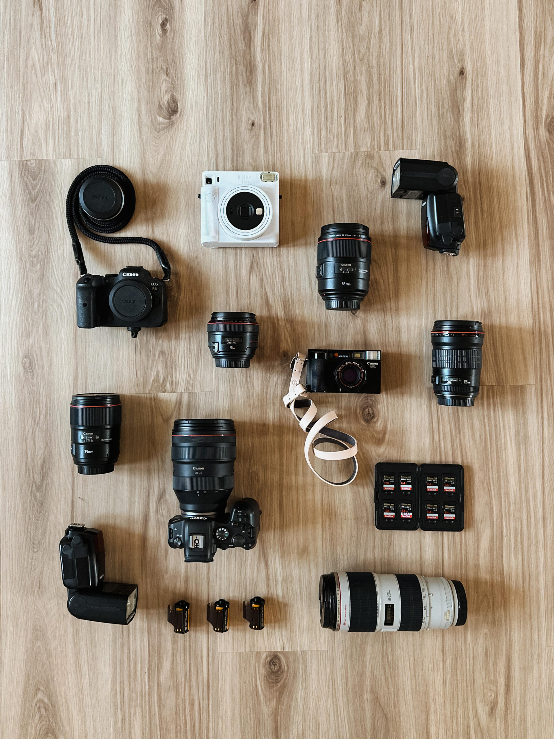 a flat lay of the various camera bodies and lenses i use on wedding days